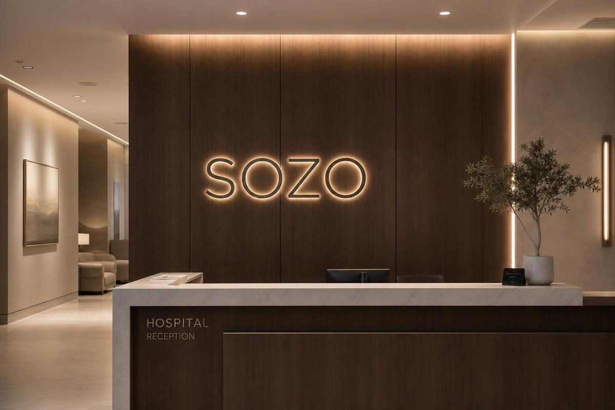 SOZO wordmark illuminated on a clinic reception wall